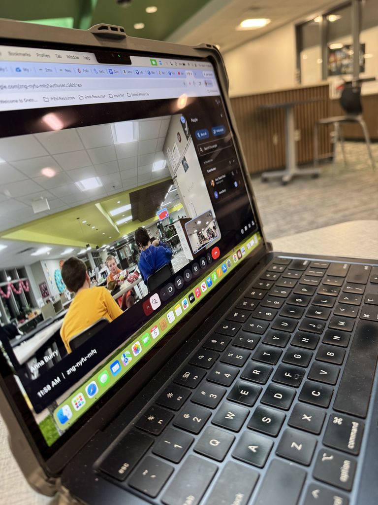 Shows a computer screen with a google meet meeting displayed on it. 