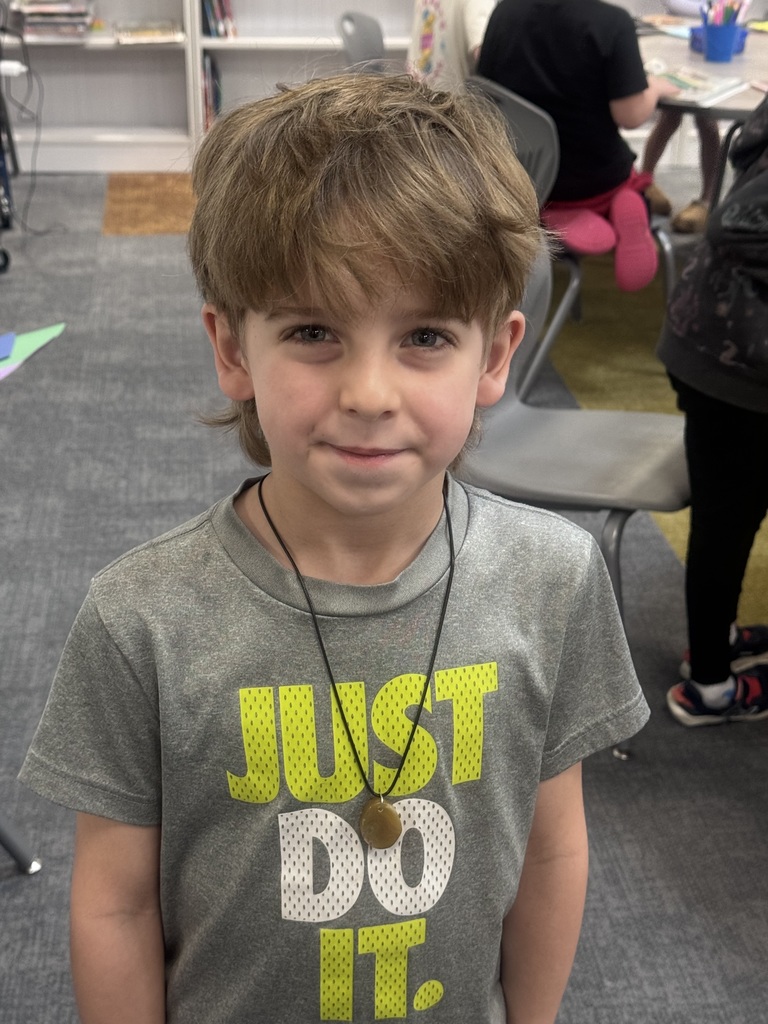 a student smiling in the library
