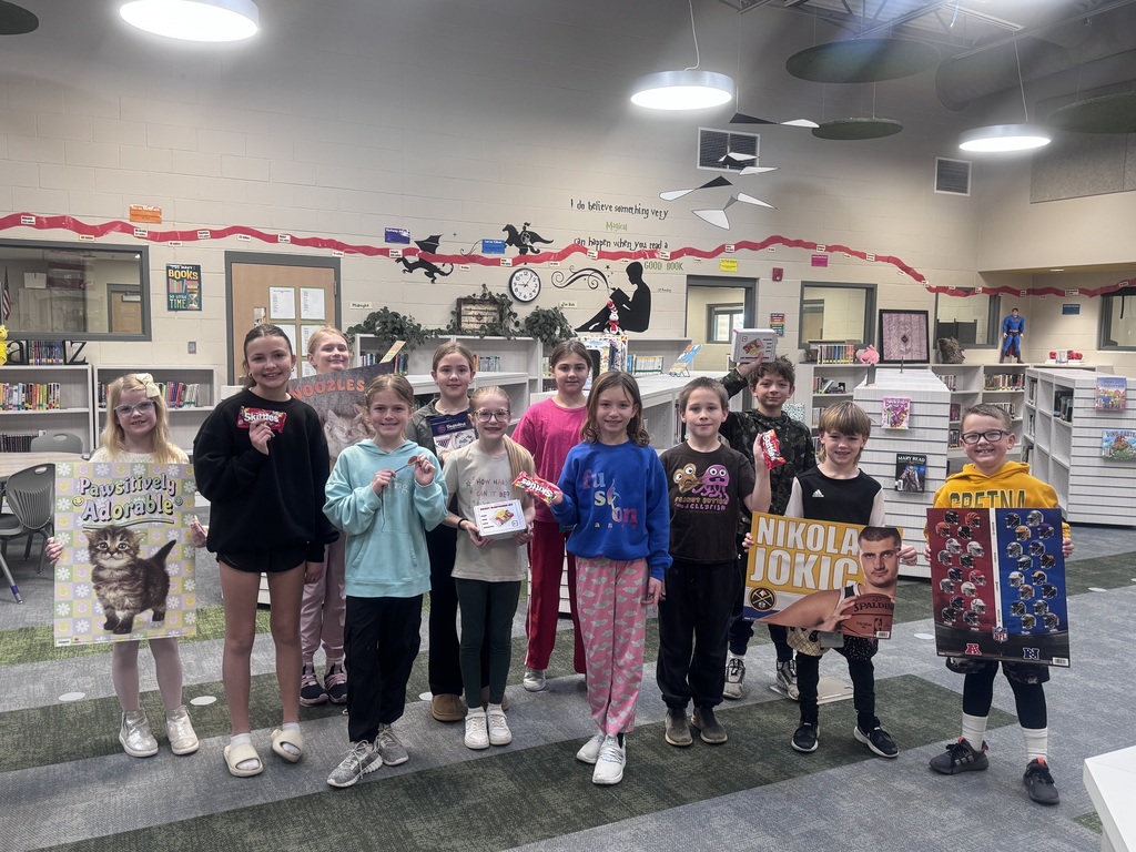 a group of students smiling in the library