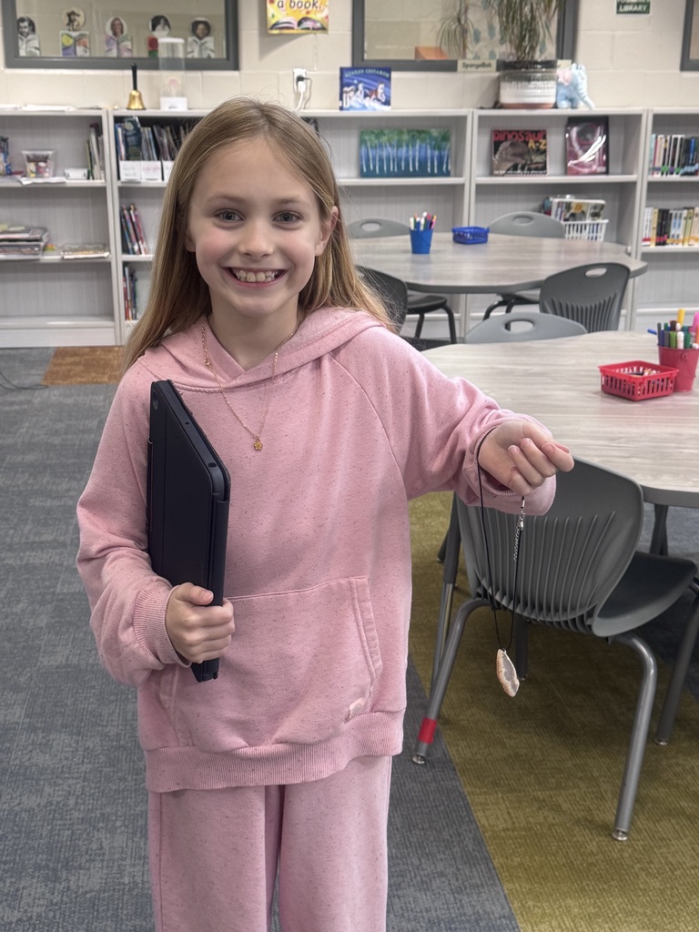 a student smiling in the library