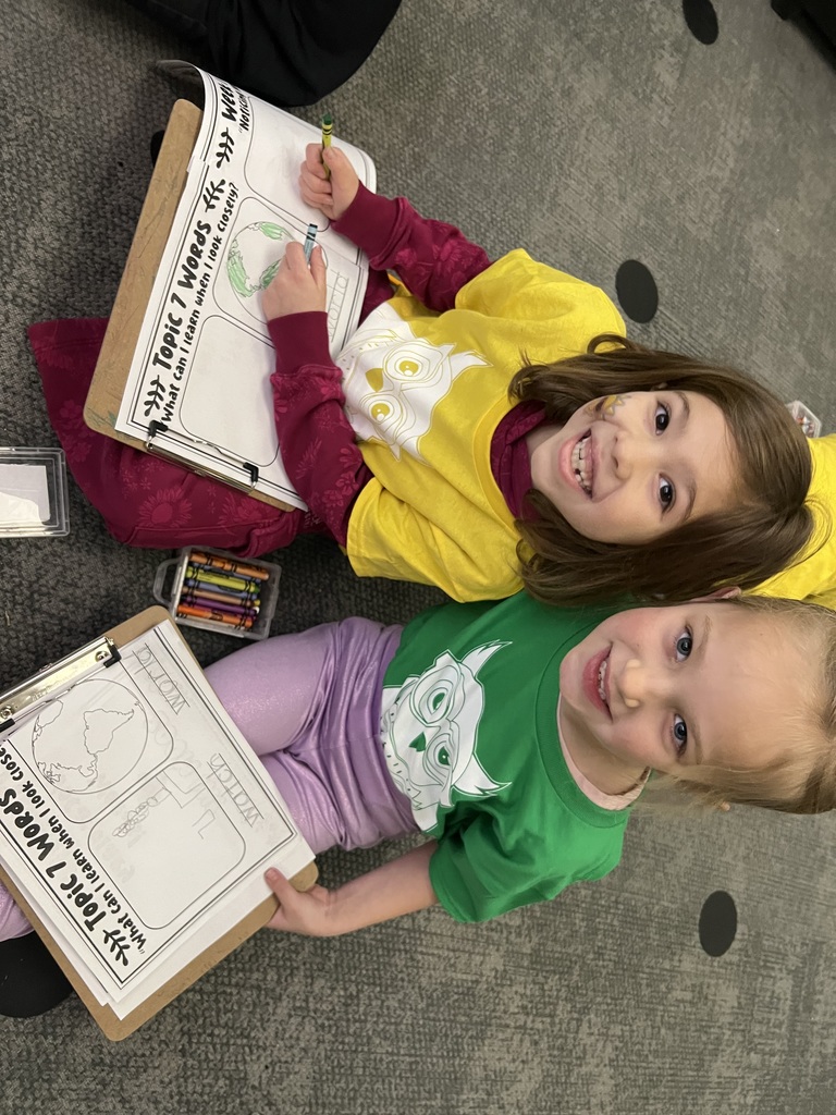 students posing in a classroom doing science or social studies