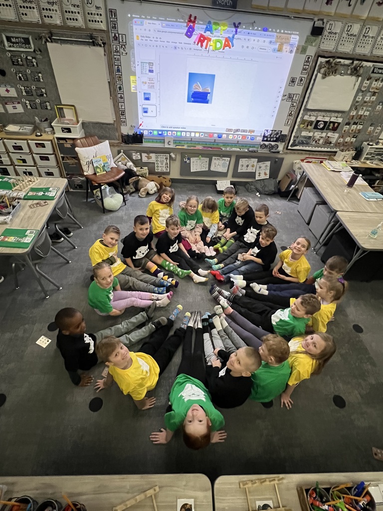 students posing with their socks for read across america week