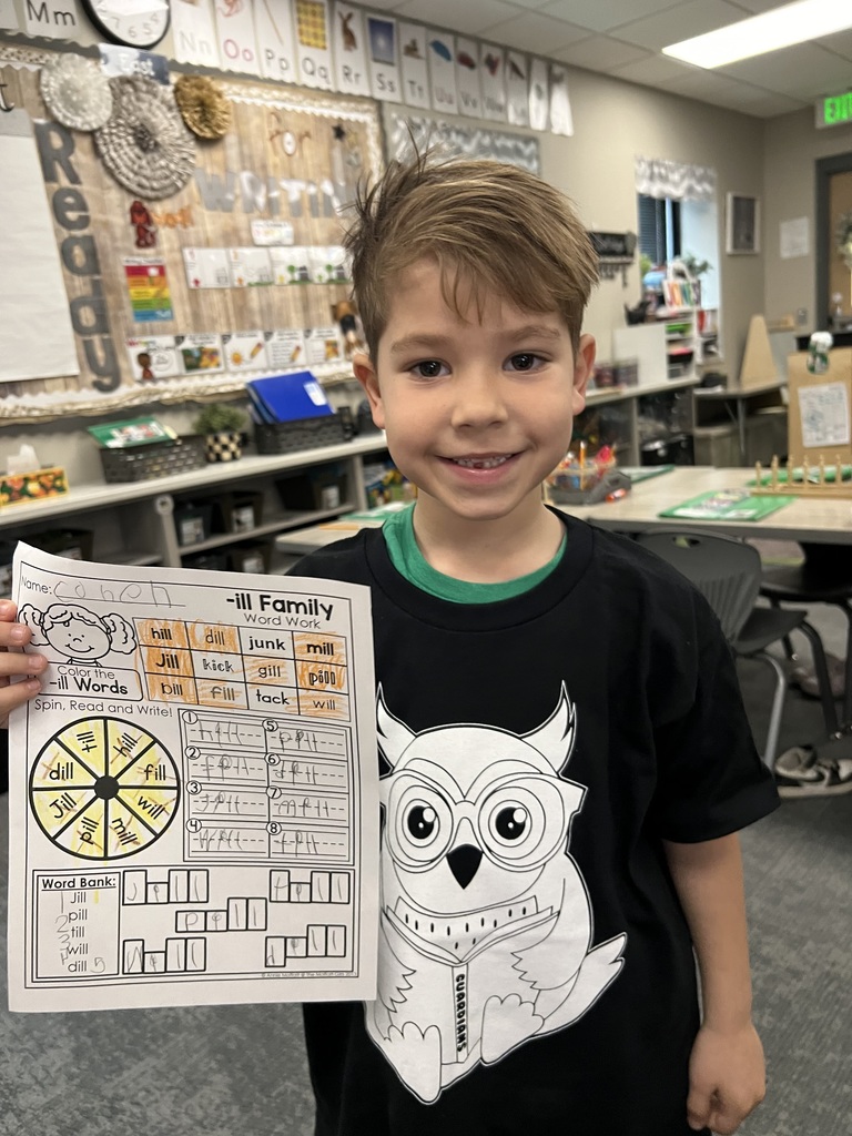 student posing with their work