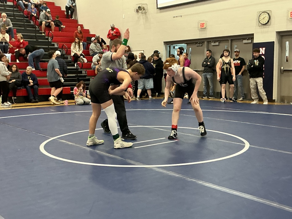 Two kids are preparing to wrestle. 