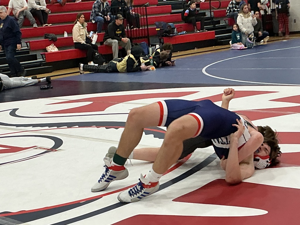 Two kids are wrestling. 