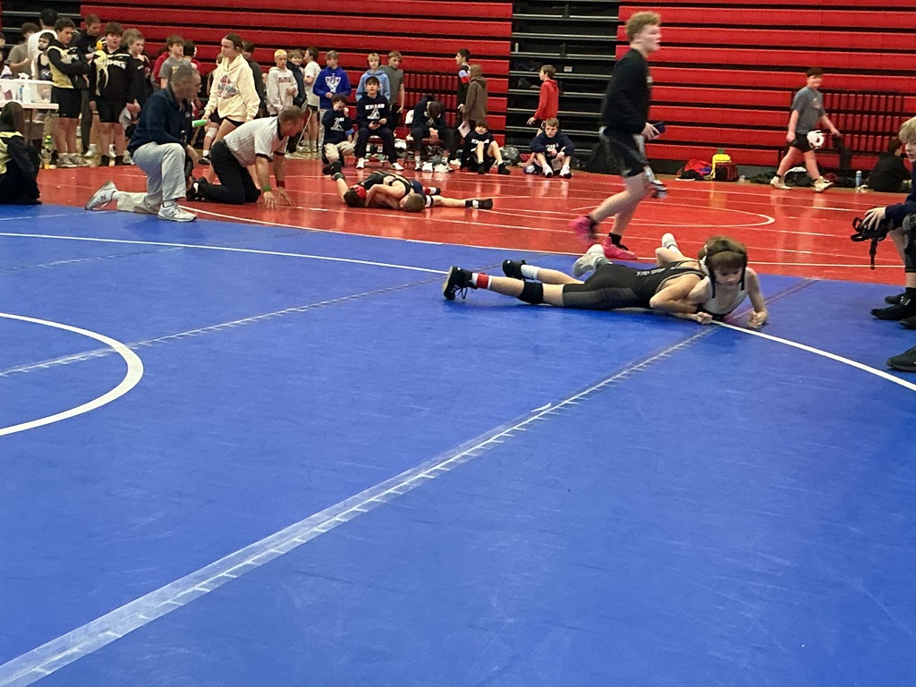 Two kids are wrestling. 