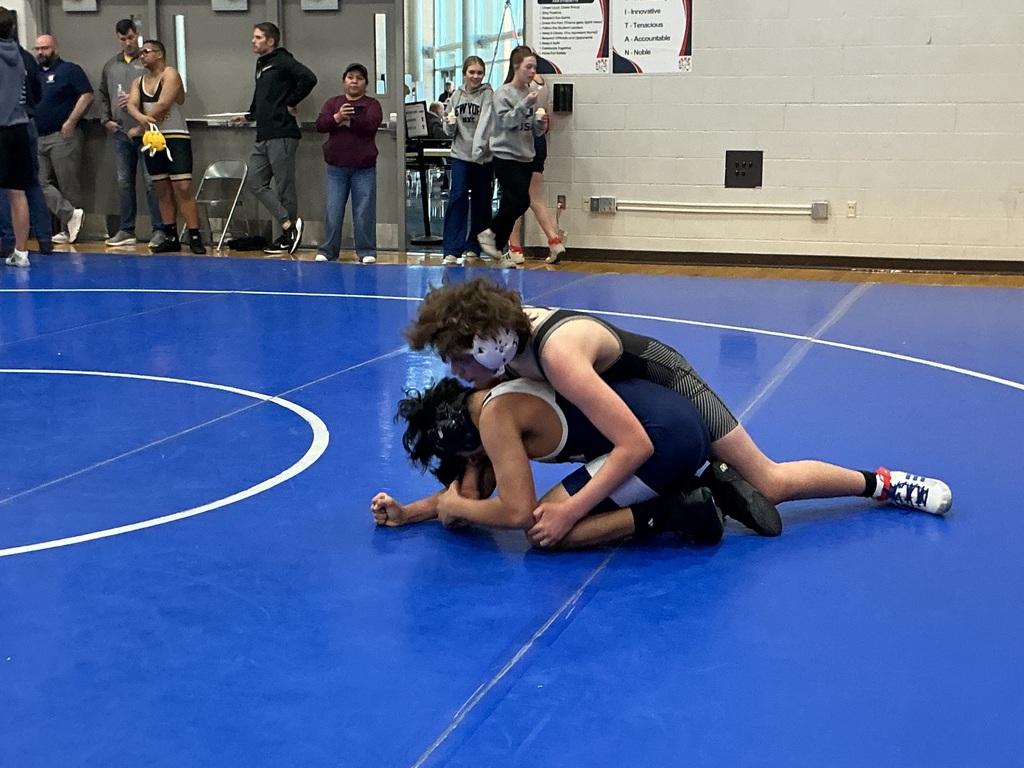 Two kids are wrestling. 