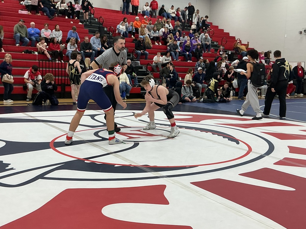 Two kids are preparing to wrestle. 