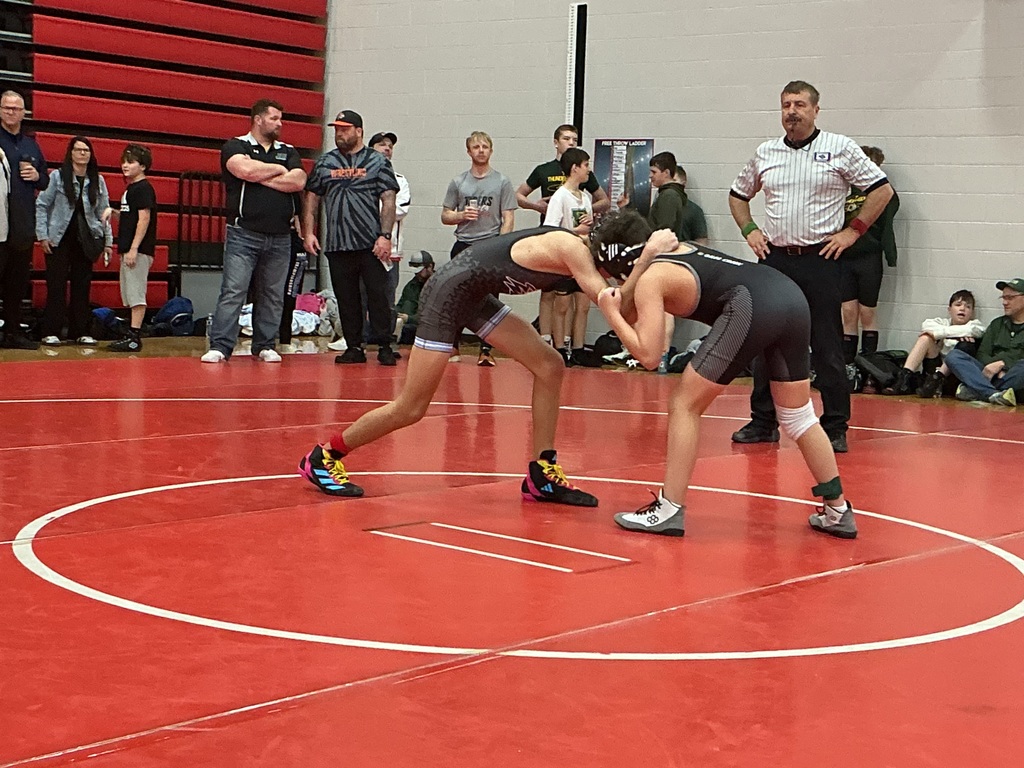 Two kids are wrestling. 