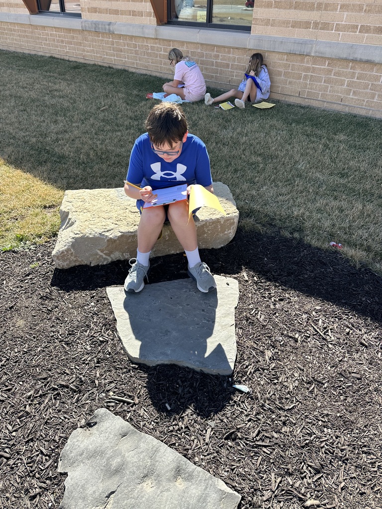 students working outside at a picnic table