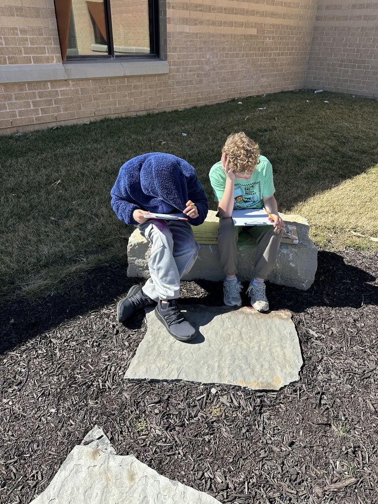 students working outside at a picnic table