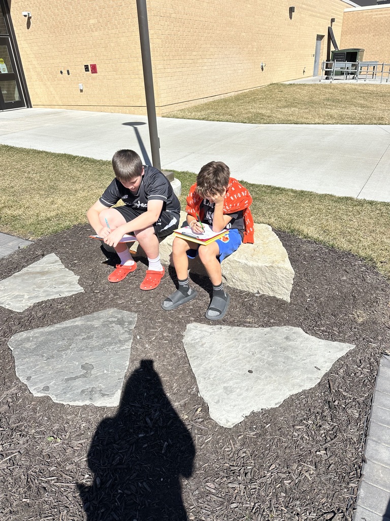 students working outside at a picnic table