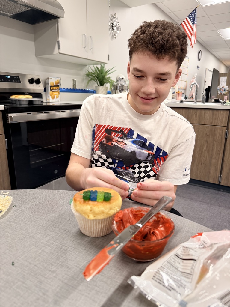A student is decorating cupcakes.