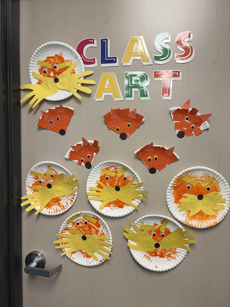 A door covered with paper plate lorax crafts and paper plate fox crafts.