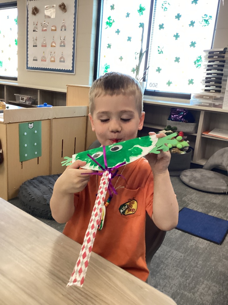 student blowing into a toy they created