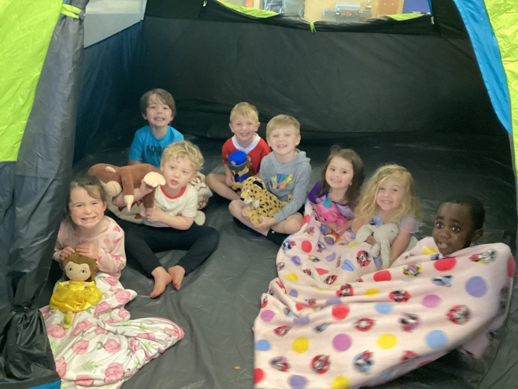 students smiling in a tent