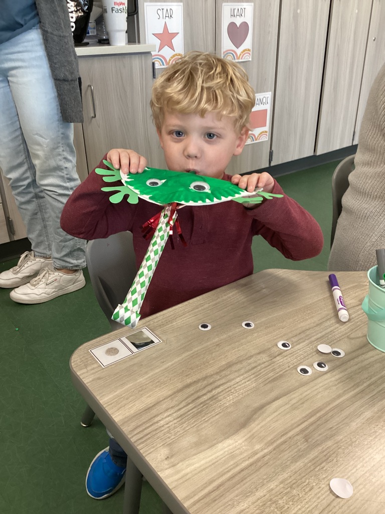 student blowing into a toy they created