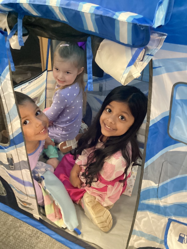 students smiling in a tent