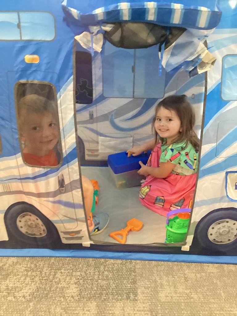 student smiling in a tent