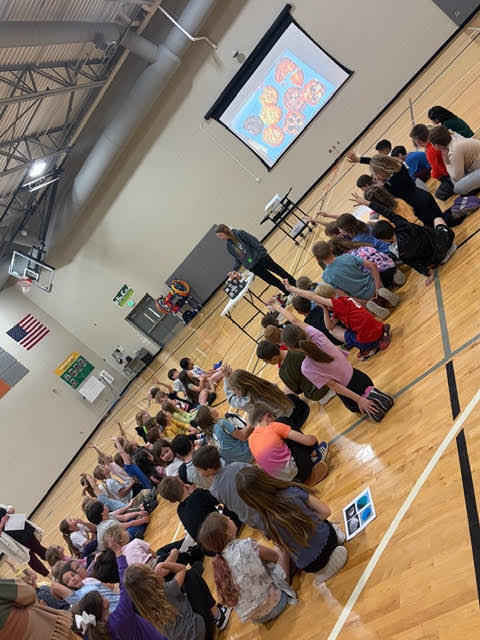 students listening to a presentation prior to a flame lab