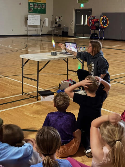 a teacher lights a flame in a lab