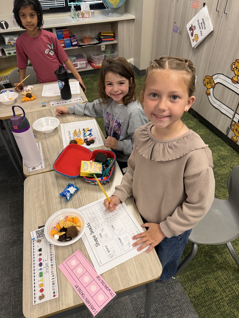 first graders using snacks to make shapes, graph, and collect data.