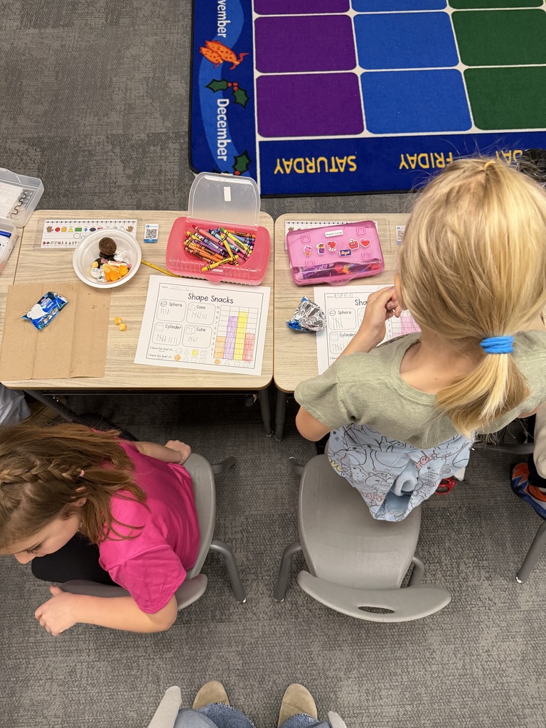 first graders using snacks to make shapes, graph, and collect data.