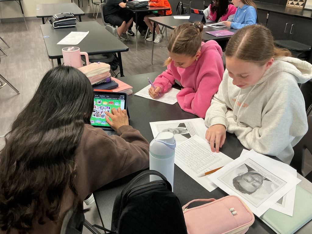 Photo of three female students working on a sorting activity on their iPads.
