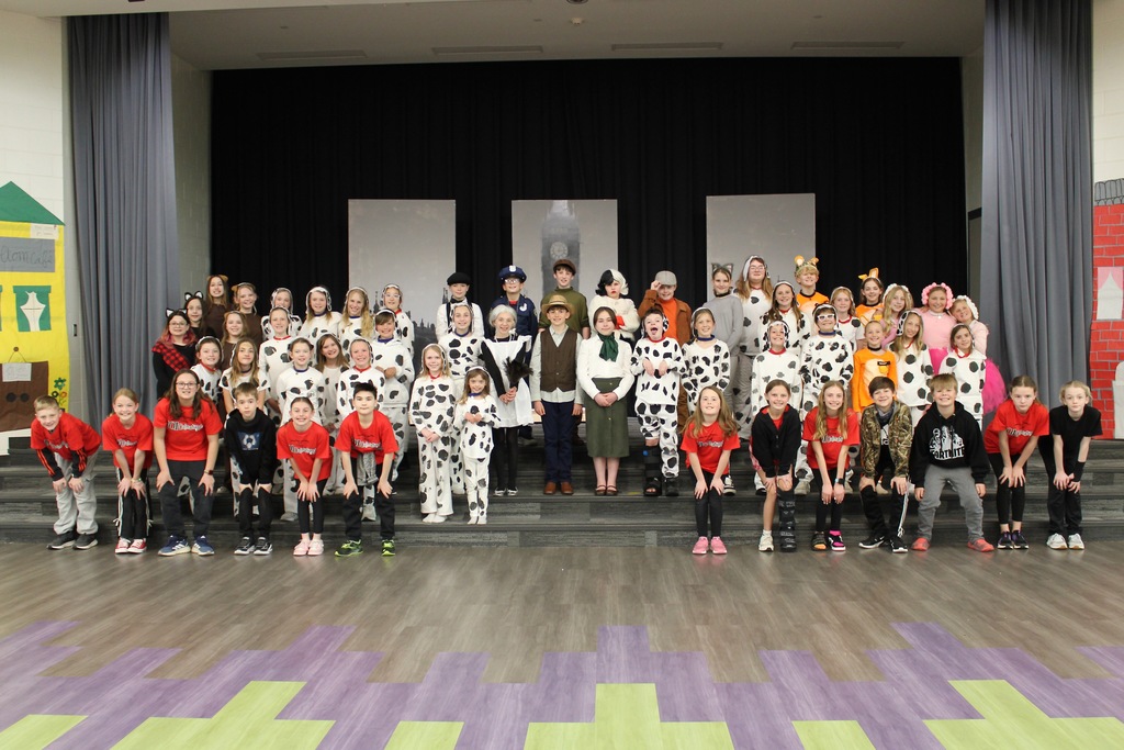 A cast picture with students in their costumes for 101 Dalmatians.
