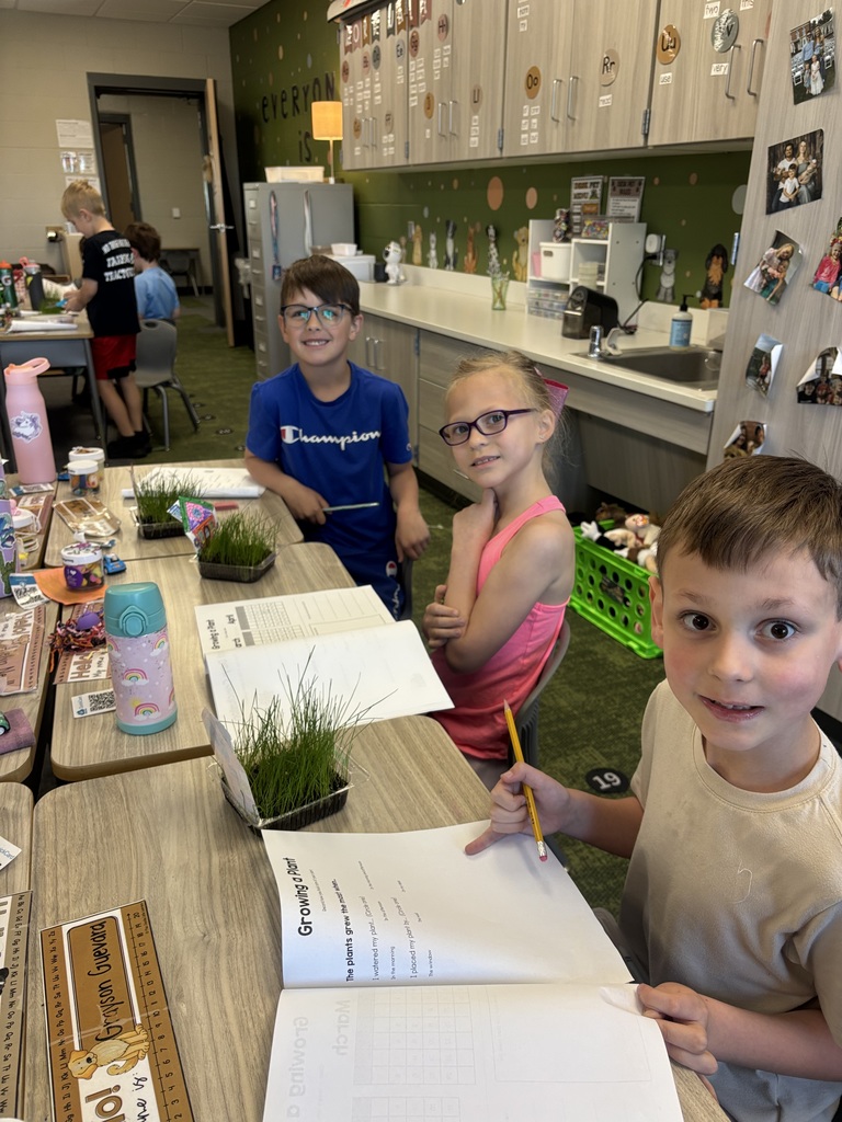 students taking notes with their grass that they grew in the classroom