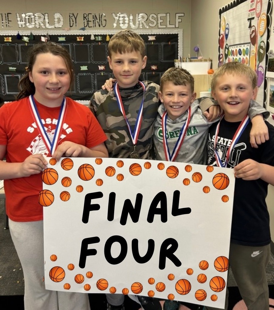 students holding up a final four poster with medals