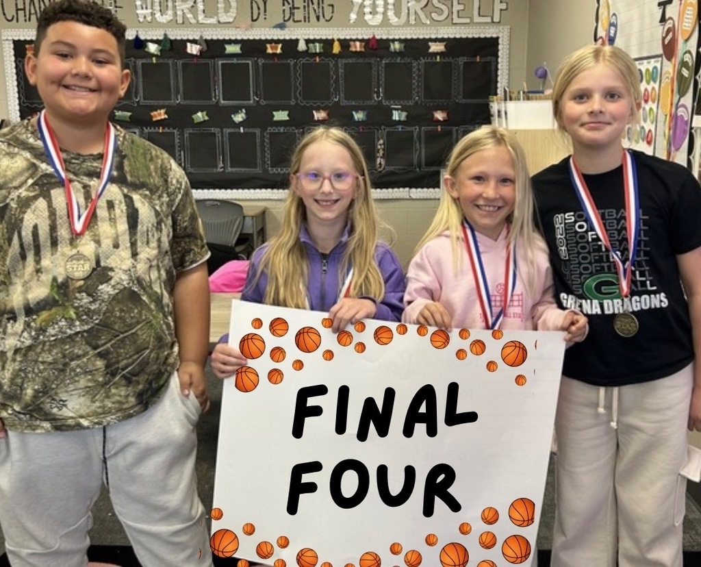 students holding up a final four poster with medals
