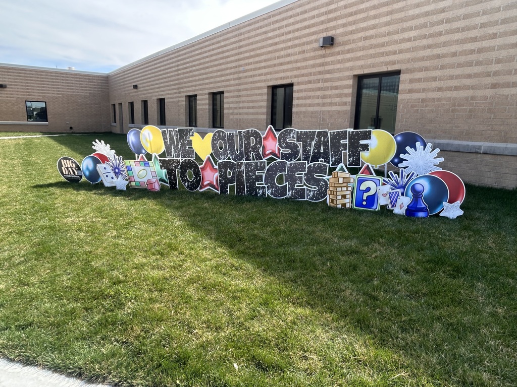 picture of yard signs that read "we love our staff to pieces"