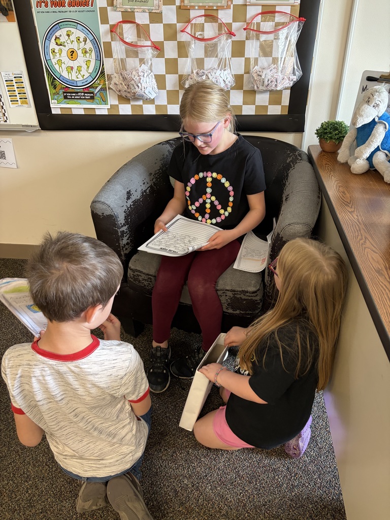 Students sitting down and reading their writing to each other.
