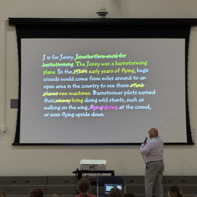 Jerry Pallotta stands in front of a screen showing edits he made on his writing  