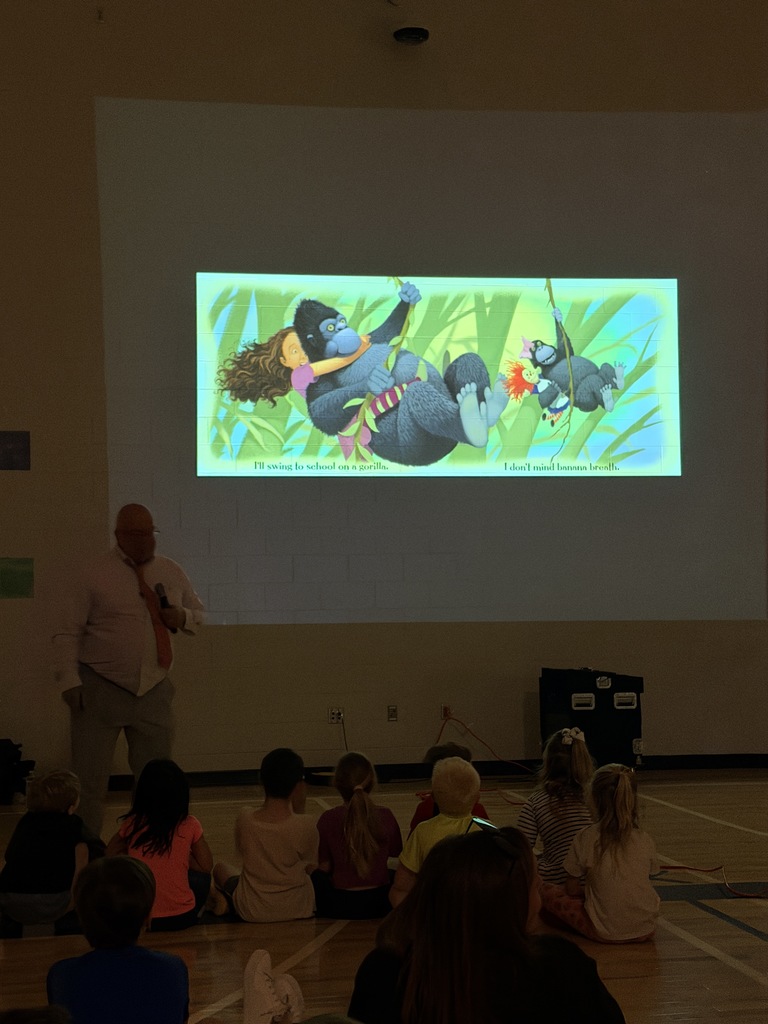 Students listening to Jerry Pallotta sharing about his book on how students can travel to school. 