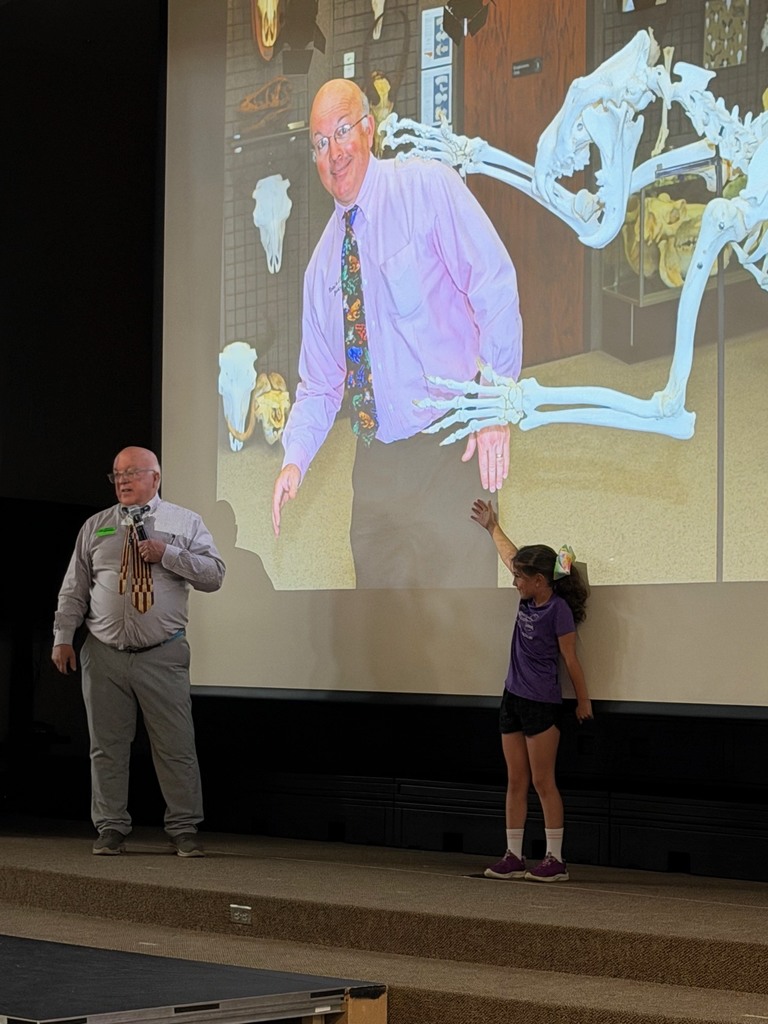 A photo of Jerry Pallotta and an elementary student on stage.