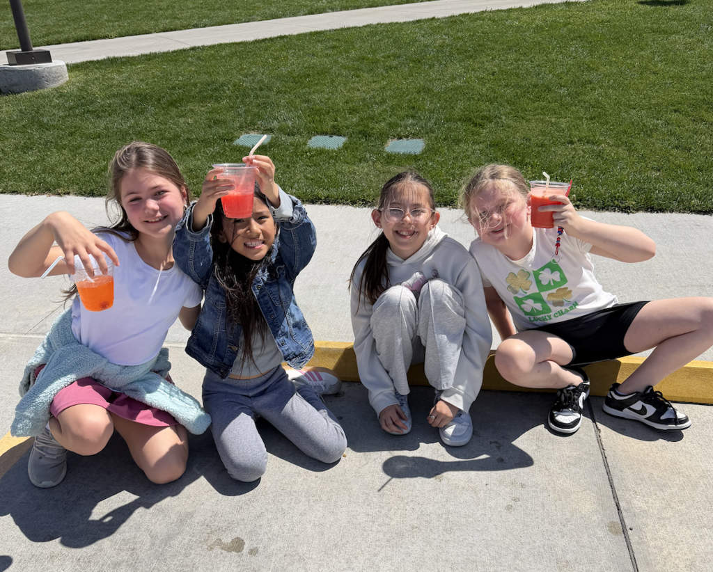 students sitting outside playing