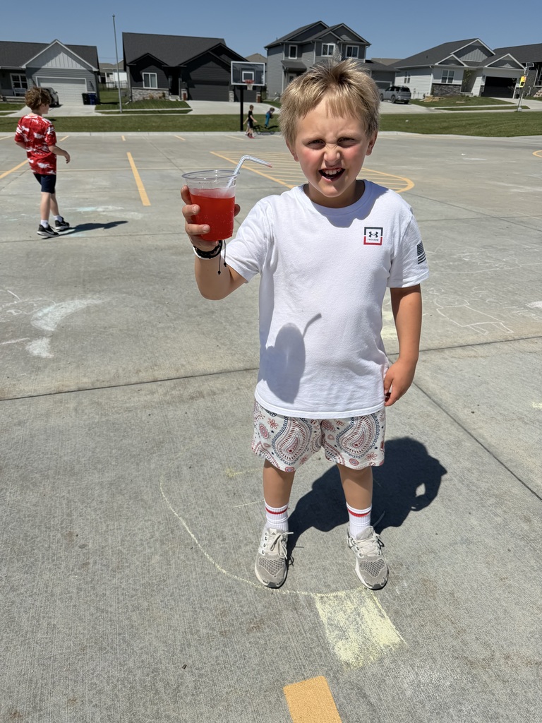 student holding up his soda 