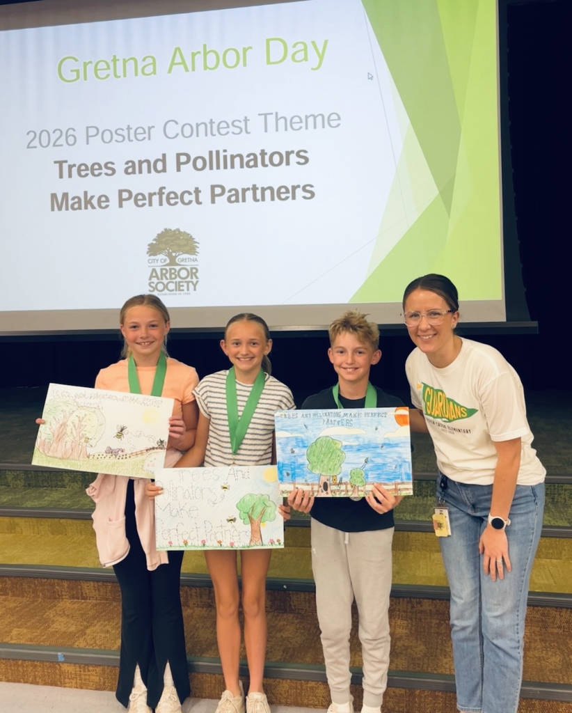 Picture of Mrs. Kelly and three students who won the Arbor Day poster contest.