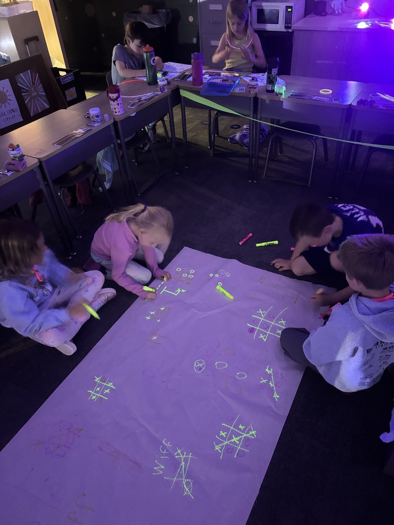 students playing tic tac toe at a glow party with highlighters