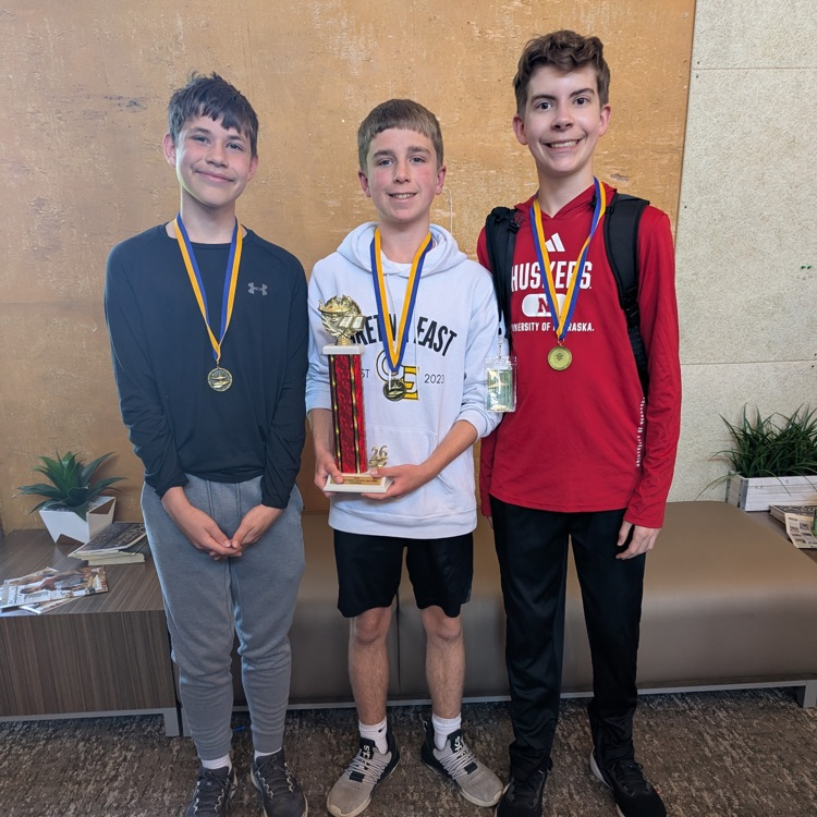 Picture of three quiz bowl students standing with their medals for winning first place