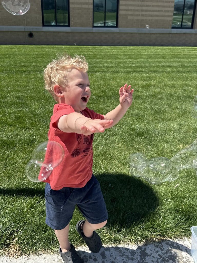kids playing with bubbles outside