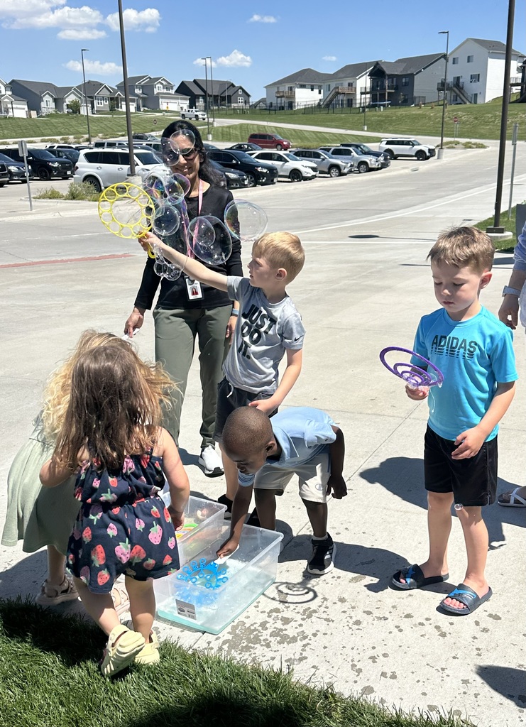 kids playing with bubbles outside