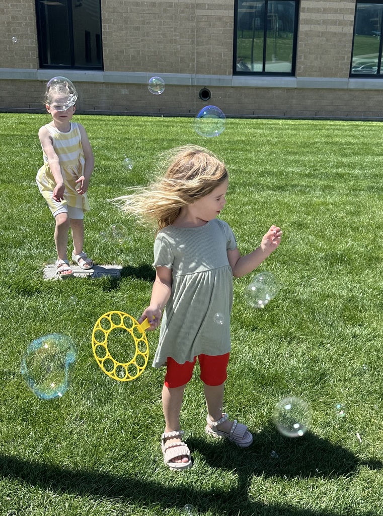 kids playing with bubbles outside