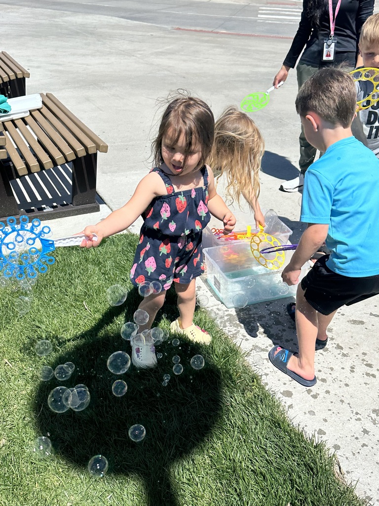 kids playing with bubbles outside