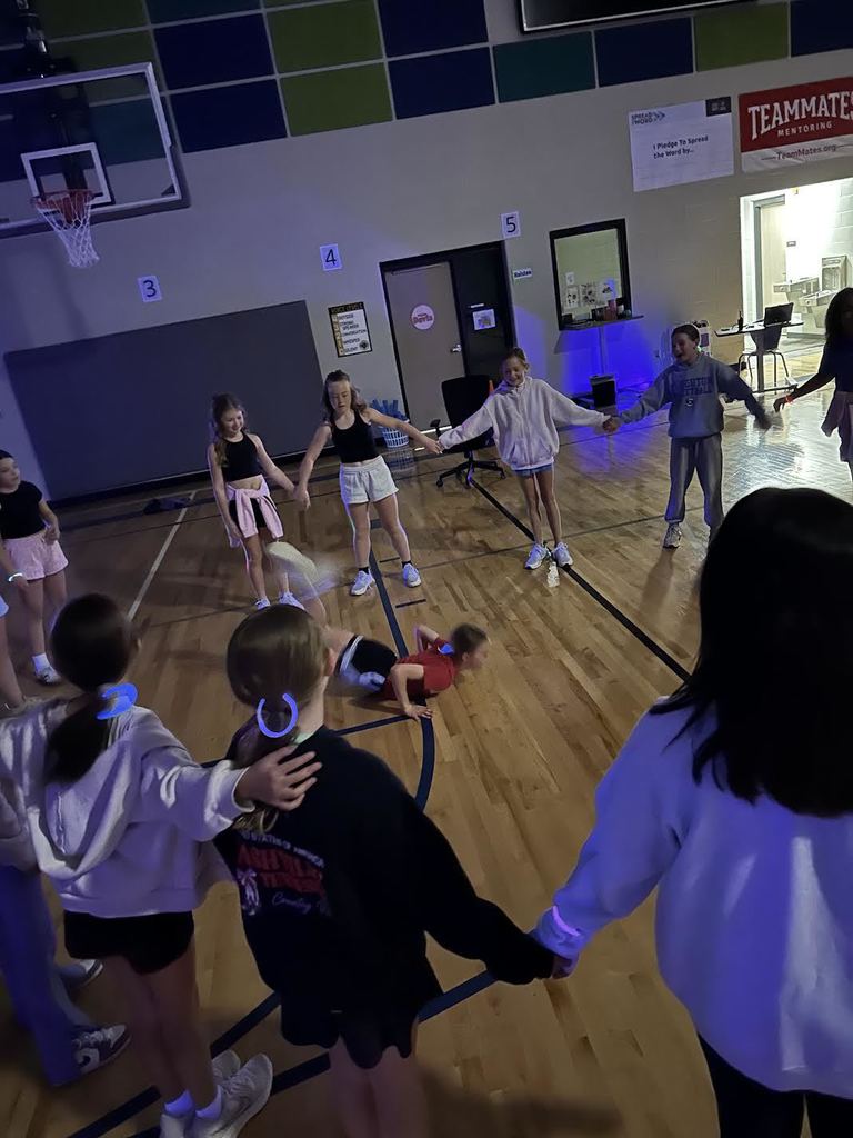 4th grade girls circle around as they show off their dance moves. 