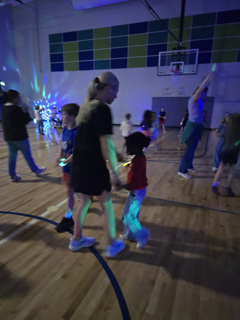 A first grade students dances with Ms. Davis during the party. 