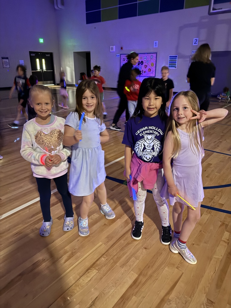 Kindergarten girls pose together to take a picture. 