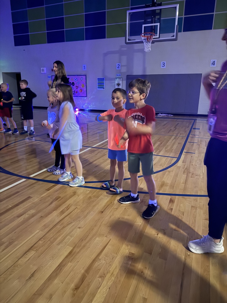 Kindergarten students circle around to do the chicken dance together! 